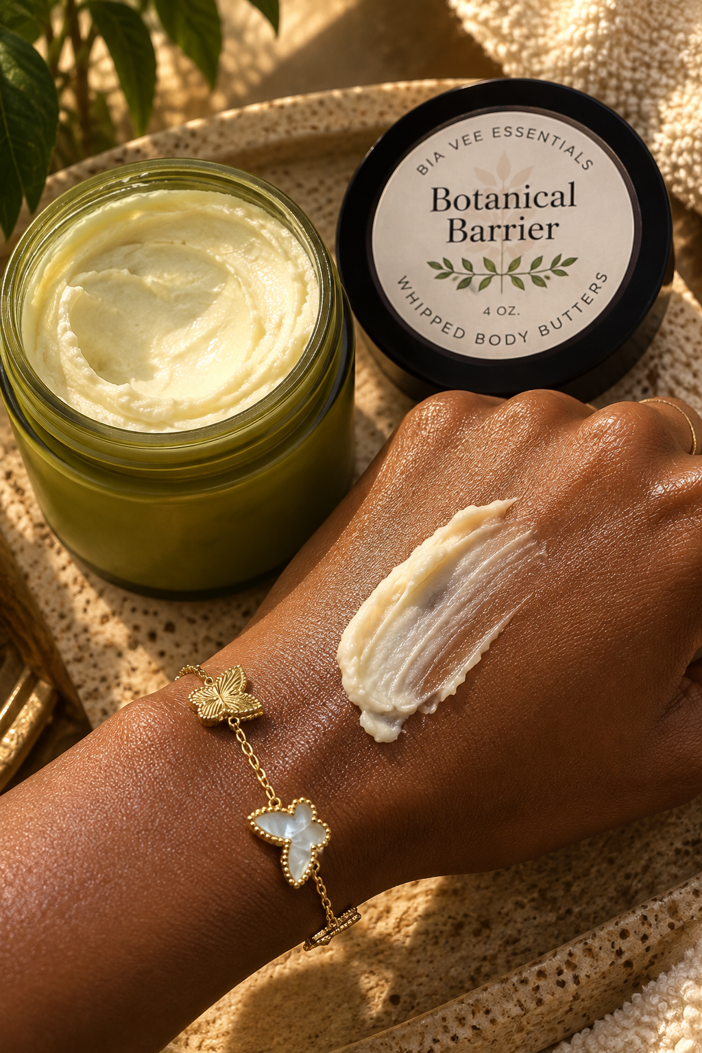 Botanical Barrier Whipped Body Butter applied to moisturized brown skin beside open Bia Vee Essentials jar